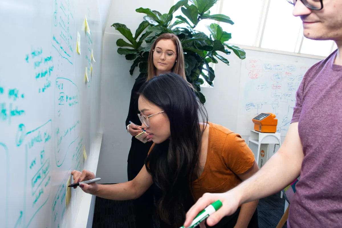 Atomix team working on a whiteboard